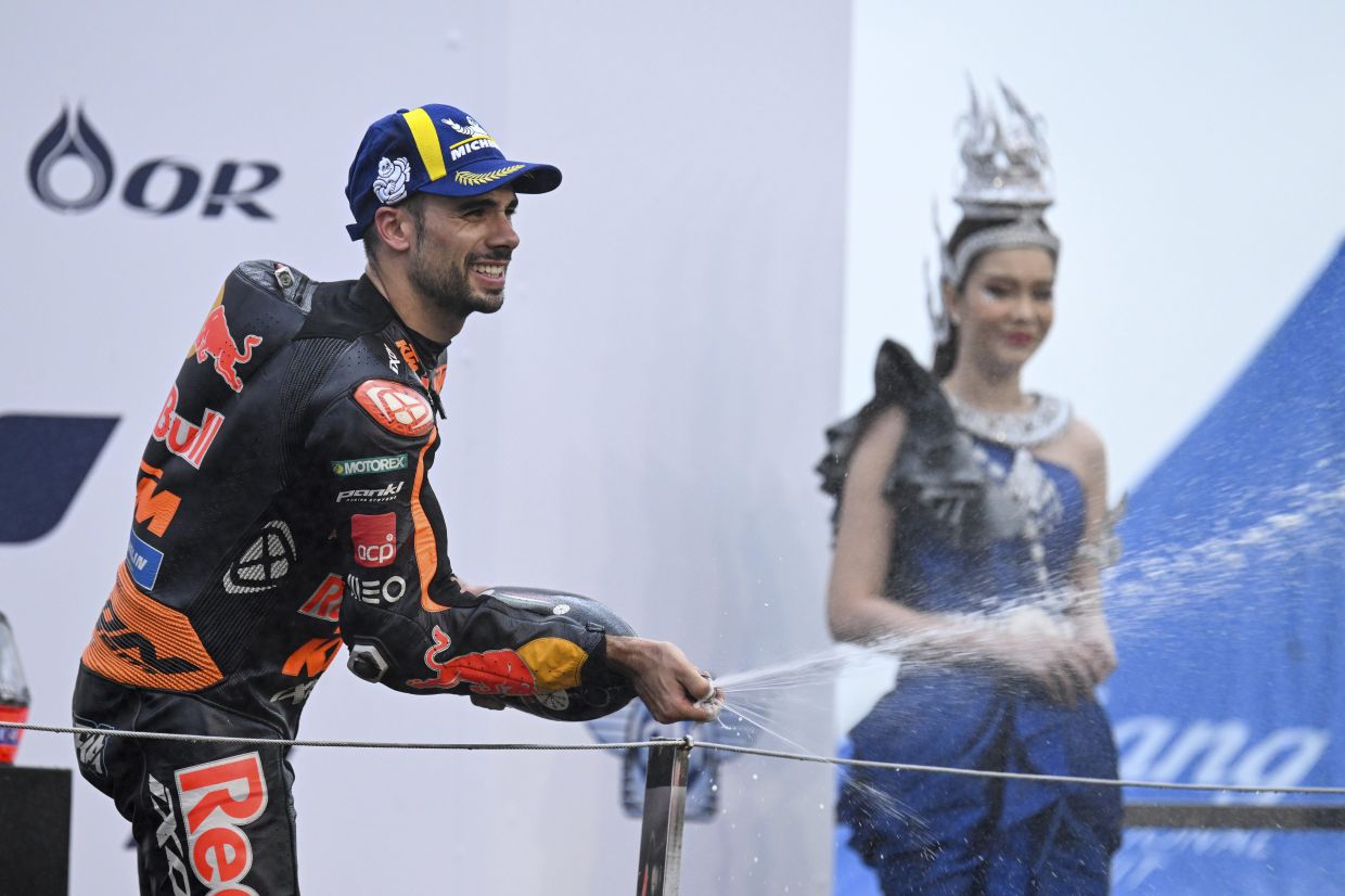 Portugal's rider Miguel Oliveira celebrates during the awards ceremony after winning the MotoGP at the Chang International Circuit in Buriram, Thailand, Sunday, Oct. 2, 2022. - AP