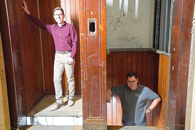 Robin Augenstein (left) and Patric Wagner in the world’s oldest paternoster elevator in the Fluggerhaus building in Hamburg harbour, Germany.