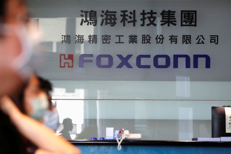 FILE PHOTO People wear masks to protect themselves from the coronavirus disease COVID-19 while listening to the annual general meeting at the lobby of Foxconns office in Taipei Taiwan June 23 2020. REUTERSAnn WangFile Photo  GLOBAL BUSINESS WEEK AHEAD