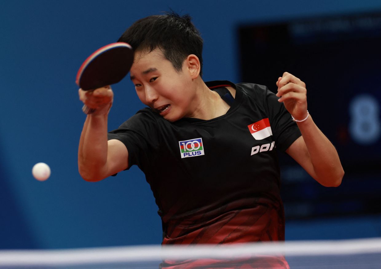 Singapore's Jingyi Zhou plays a shot against South Korea's Lee Zion during the World Team Championships Finals table tennis women's group match in Chengdu in China's southwestern Sichuan province. - AFP