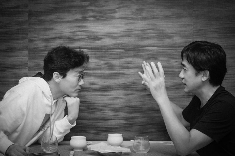 Hwang Dong-hyuk and Tony Leung Chiu Wai deep in discussion. Photo: Carina Lau/Instagram