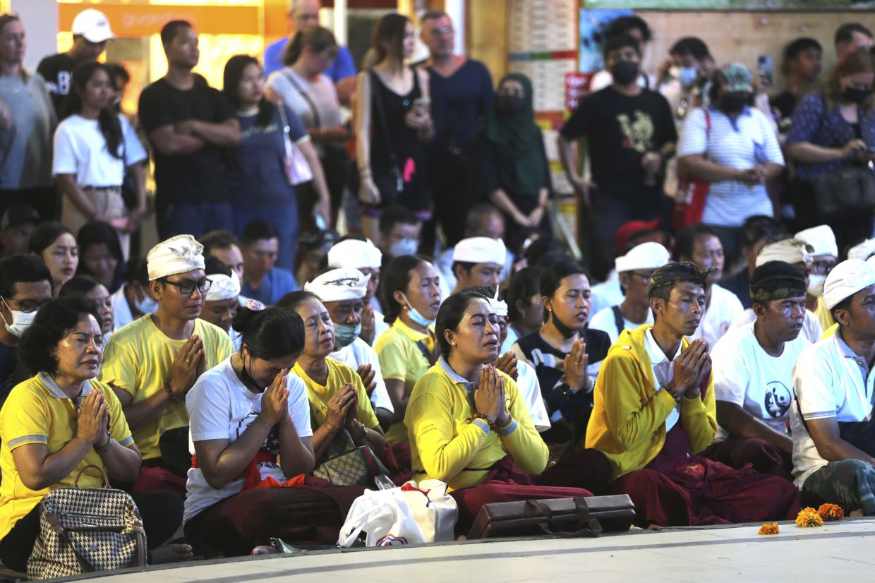People pray for the Bali bombing victims during the commemoration of the 20th anniversary of the attack that killed 202 people, mostly foreign tourists, including 88 Australians and seven Americans, at the Bali Bombing Memorial Monument in Kuta, Bali, Indonesia on Wednesday, Oct. 12, 2022. Services were held in several places in Australia and at Bali's Australian Consulate in the city of Denpasar, where Australian survivors and relatives of the deceased were among the 200 in attendance to pay tribute to their loved ones who died in the most popular tourist area on the island two decades ago. - AP