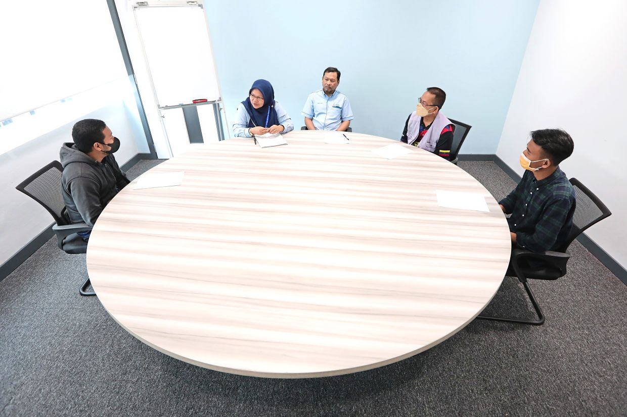 Mediators and staff members showing how a mediation session is set up with the opposing parties. — Photos: YAP CHEE HONG/The Star