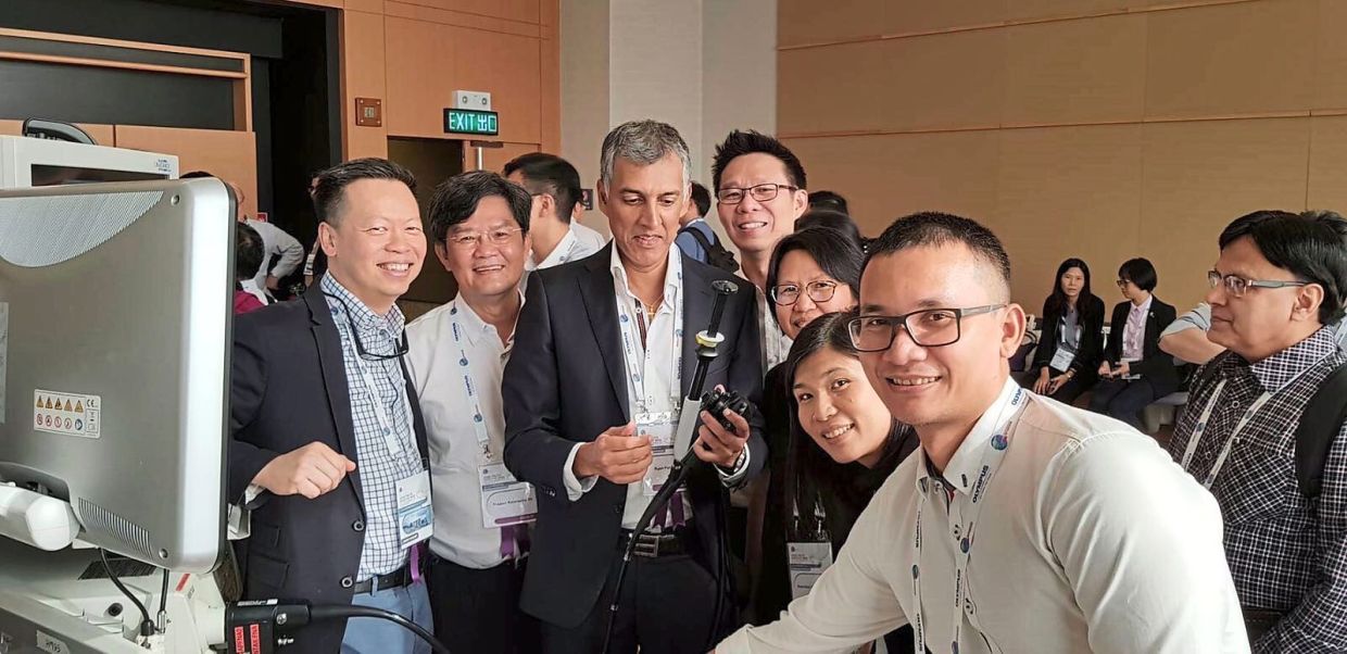 A photo from the 2018 conference in Hong Kong where Dr Ryan (centre) first felt unwell on stage.