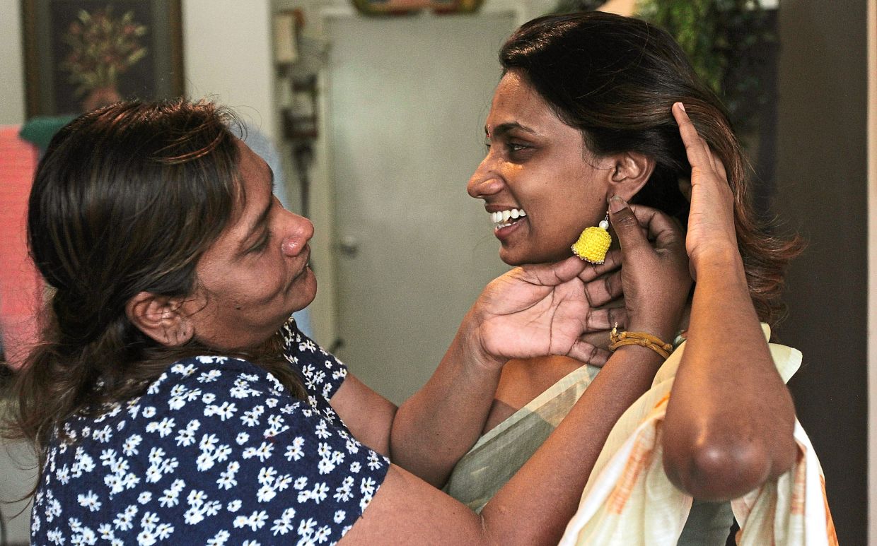 Lalita (left) says she derives great satisfaction from seeing people wear her handmade earrings.