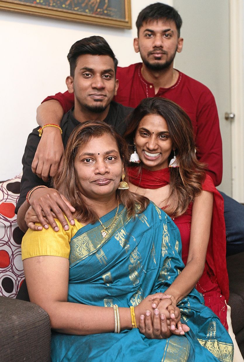 Lalita’s children Jayamunishwar (back, left), Sathishwaran and Yuveneswary (front, right) are supportive of her crochet business.