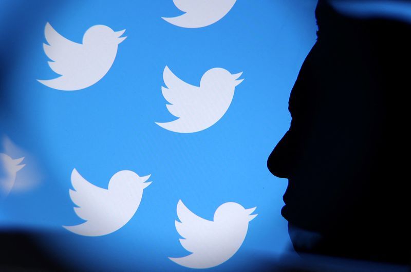 Elon Musk photo and Twitter logo are seen through magnifier in this illustration taken November 4 2022. REUTERSDado RuvicIllustration