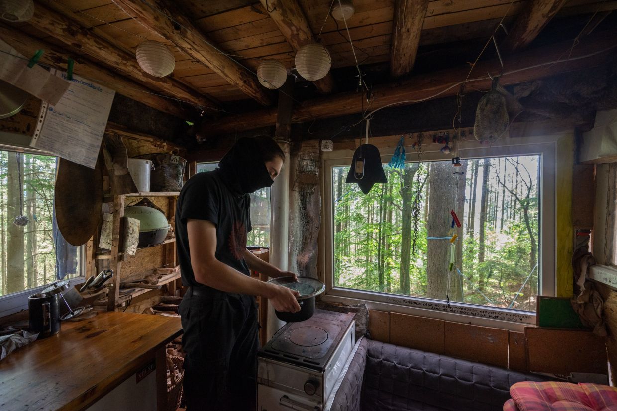 A protester at a forest near Trier, Germany, in the treehouse kitchen at their environmental camp. 