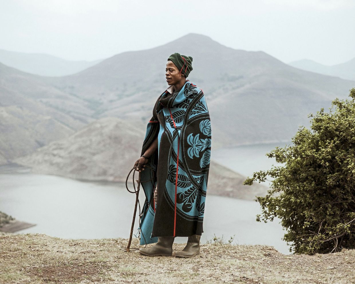 A local man draped in a traditional blanket. These blankets feature motifs loaded with meaning, from celebrating life to peace, love and courage.