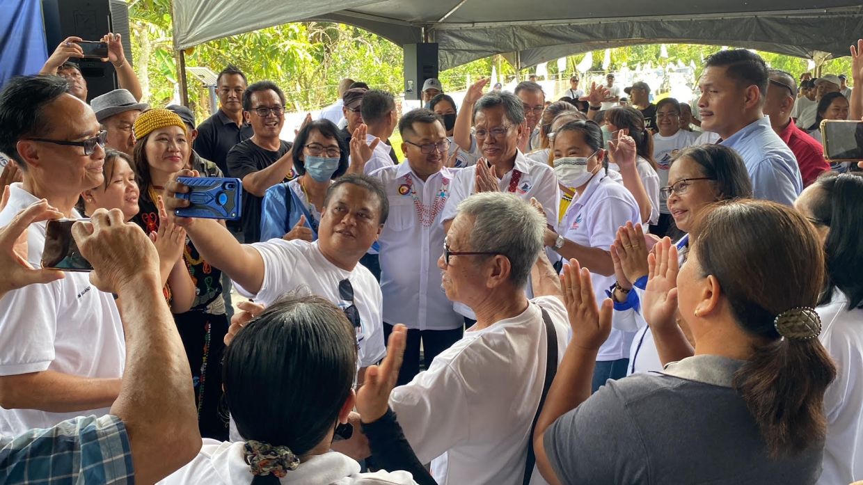 Warisan supporters jostle to take photos with Shafie in Tenom.