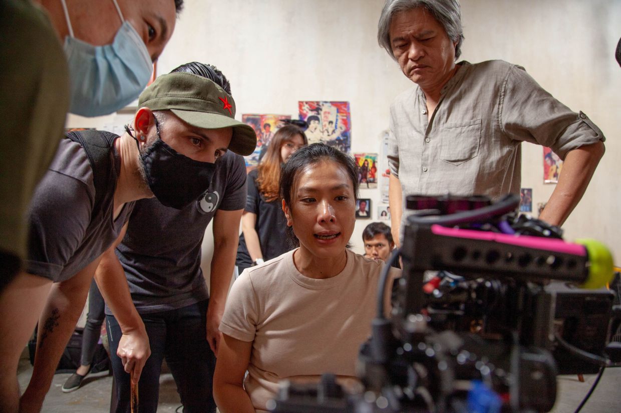 Tan Chui Mui gets the help of fellow filmmakers like Pete Teo (right) to make her third feature film. 