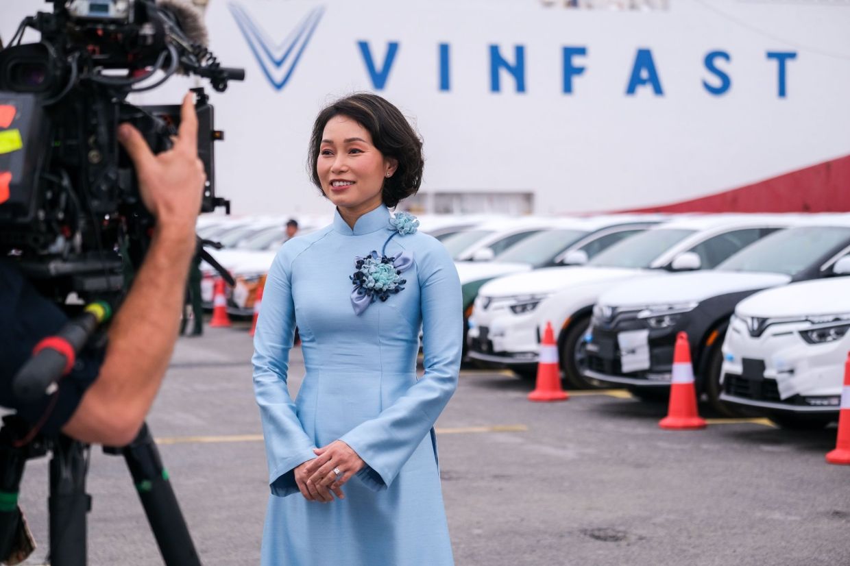 Le Thi Thu Thuy, global chief executive officer of VinFast, poses for photos during the loading of VinFast LLC's VF8 electric vehicles for shipment for export at a port in Haiphong, Vietnam. VinFast, which said in July that it had signed agreements with banks to raise at least US$4 billion to help its US expansion, has about 73,000 global reservations for its EVs, according to the company. It has secured about US$1.2 billion in incentives for its planned EV factory in North Carolina, where it intends to start production in 2024, according to the auto manufacturer.  - Bloomberg