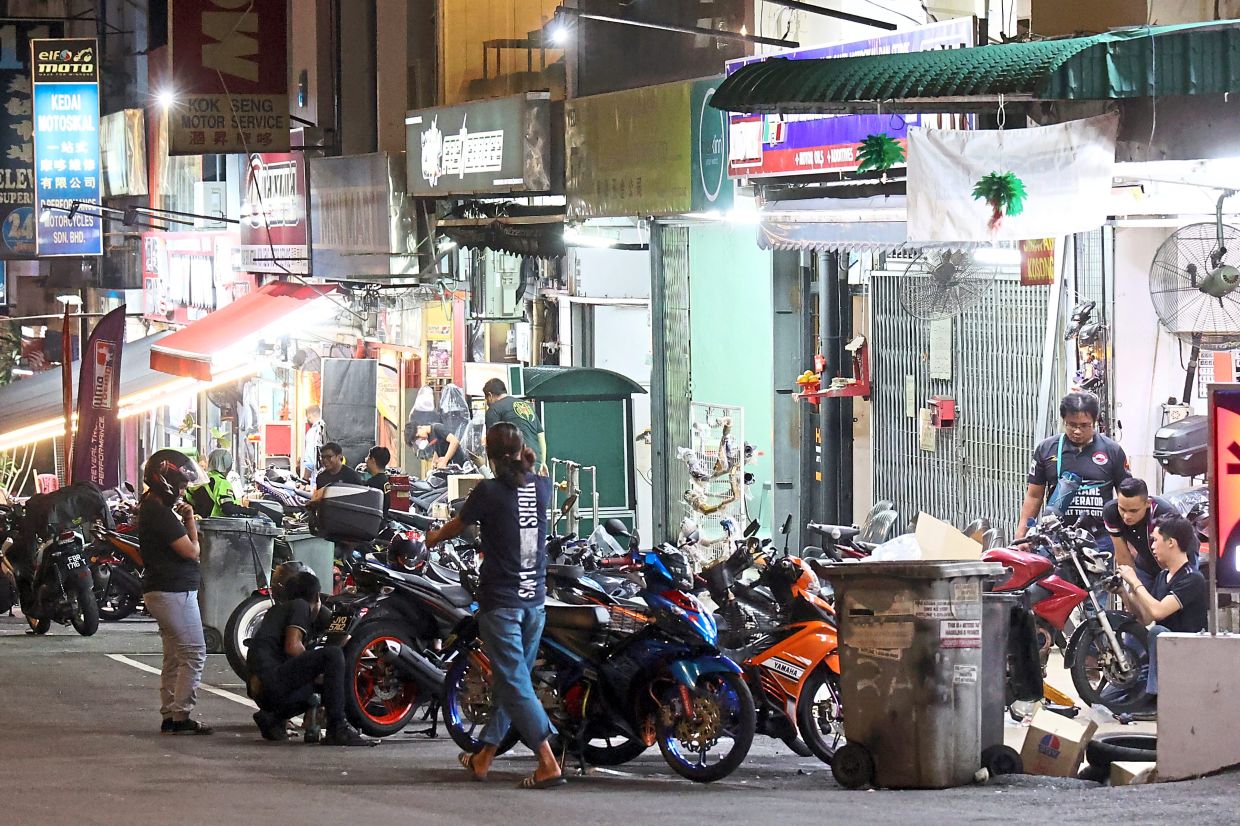 Motorcycle workshops in Jalan Tun Abdul Razak cater mostly to late-night customers. – Photos: THOMAS YONG/The Star