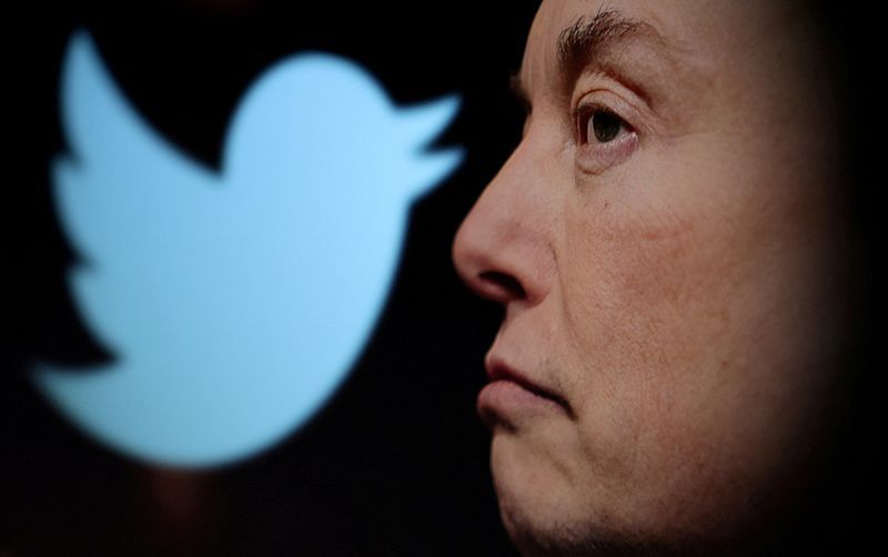FILE PHOTO Twitter logo and a photo of Elon Musk are displayed through magnifier in this illustration taken October 27 2022. REUTERSDado RuvicIllustrationFile Photo