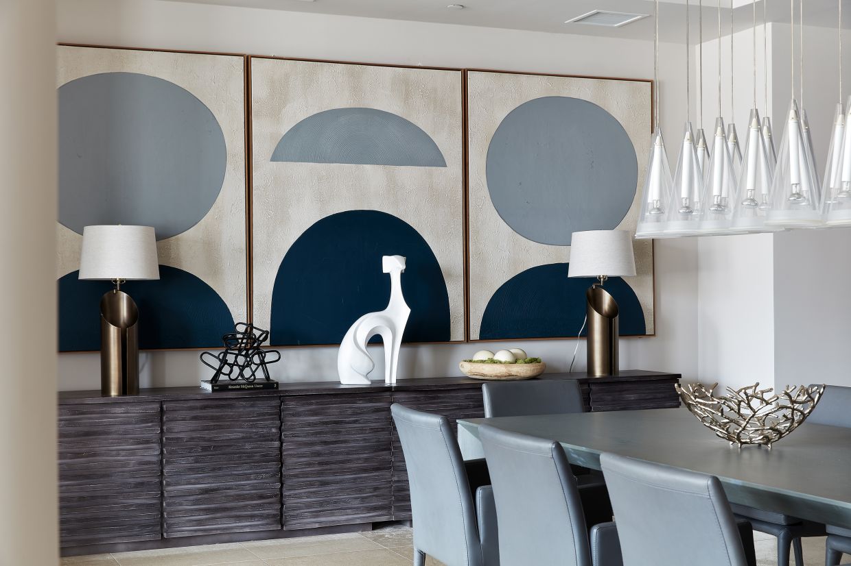 Three pieces of art hung in a series helps add rhythm to this dining room area. Photo: Scott Gabriel Morris/TNS