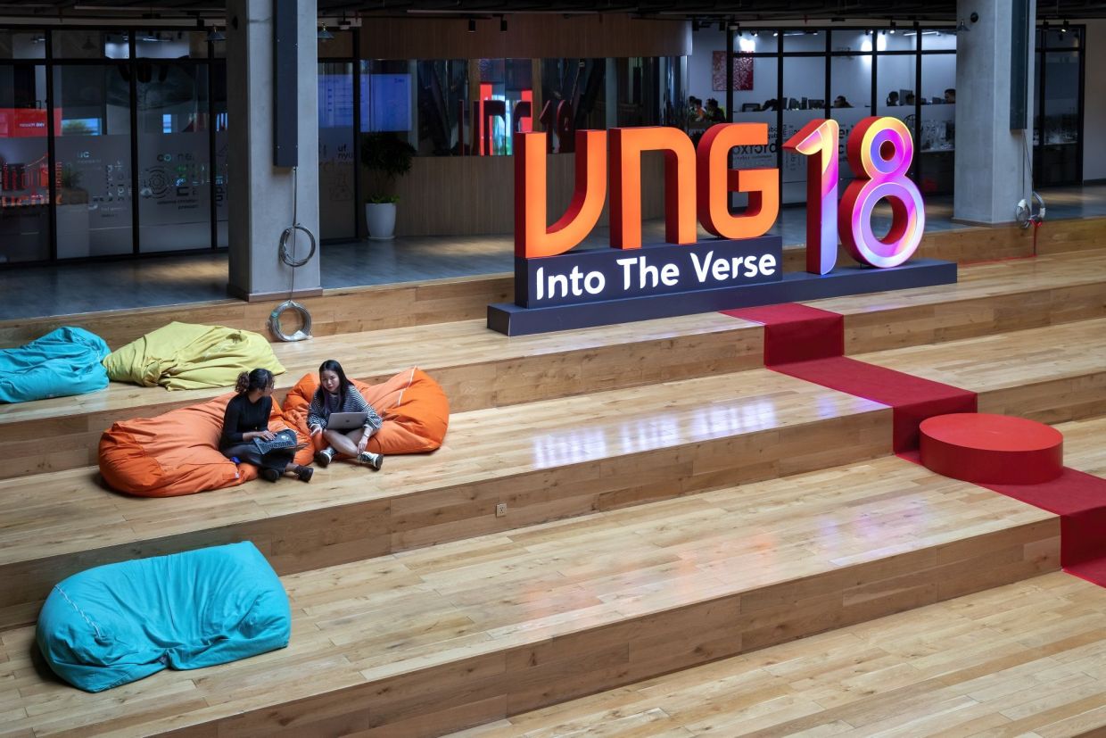 Employees on beanbags in the Atrium lobby inside VNG Corp.'s city campus in Ho Chi Minh City, Vietnam, on Thursday, Sept. 22, 2022. VNG, Vietnam’s answer to Tencent Holdings Ltd. with games, messaging, videos and music among its services, is accelerating its international expansion, co-founder Le Hong Minh said in an interview at its headquarters in Ho Chi Minh City. - Bloomberg