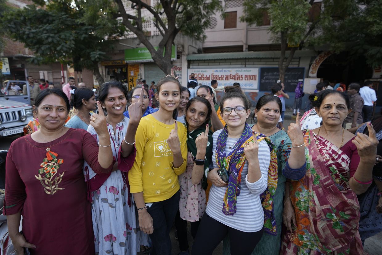 People shows their inked fingers after casting their votes during the second phase of Gujarat state legislature elections in Ahmedabad, India, Monday, Dec. 5, 2022. The local elections in Prime Minister Narendra Modi's home state is seen as a barometer of his ruling Bharatiya Janata Party's popularity ahead of a general election in 2024. - AP