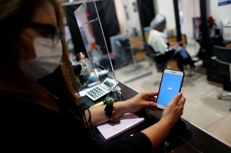 AM hair salon owner Andrea Manoli is pictured using Mercado Pago app at her store in Buenos Aires Argentina October 15 2020. REUTERSAgustin MarcarianFile Photo