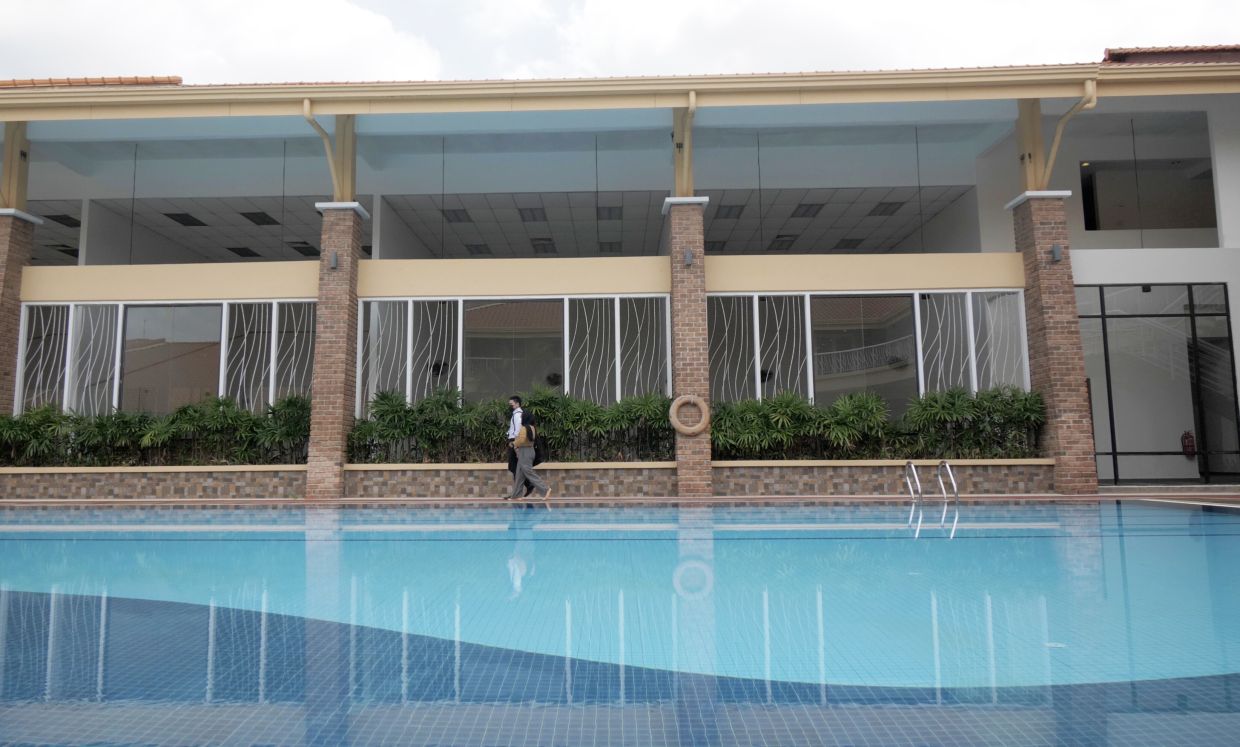 Students strolling along swimming pool after class.