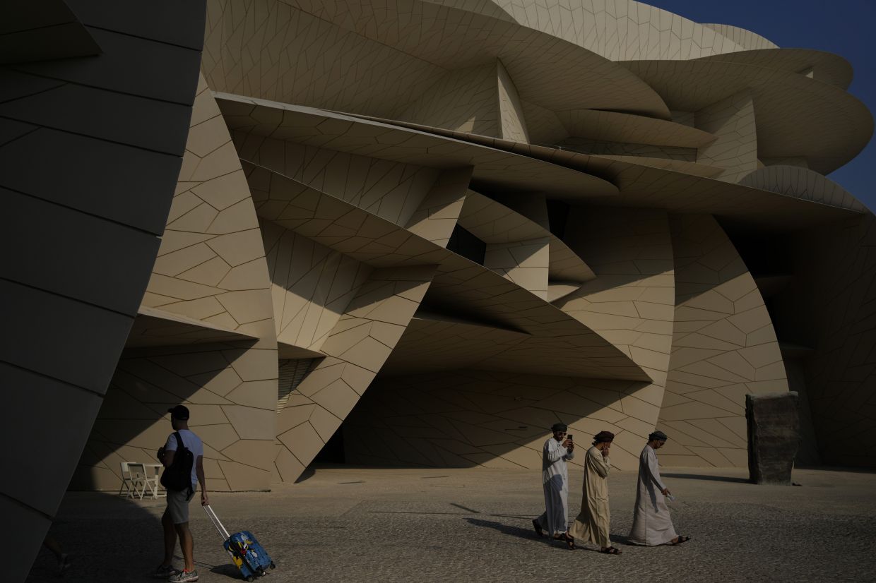 People walk outside the National Museum in Doha. Photo: AP 