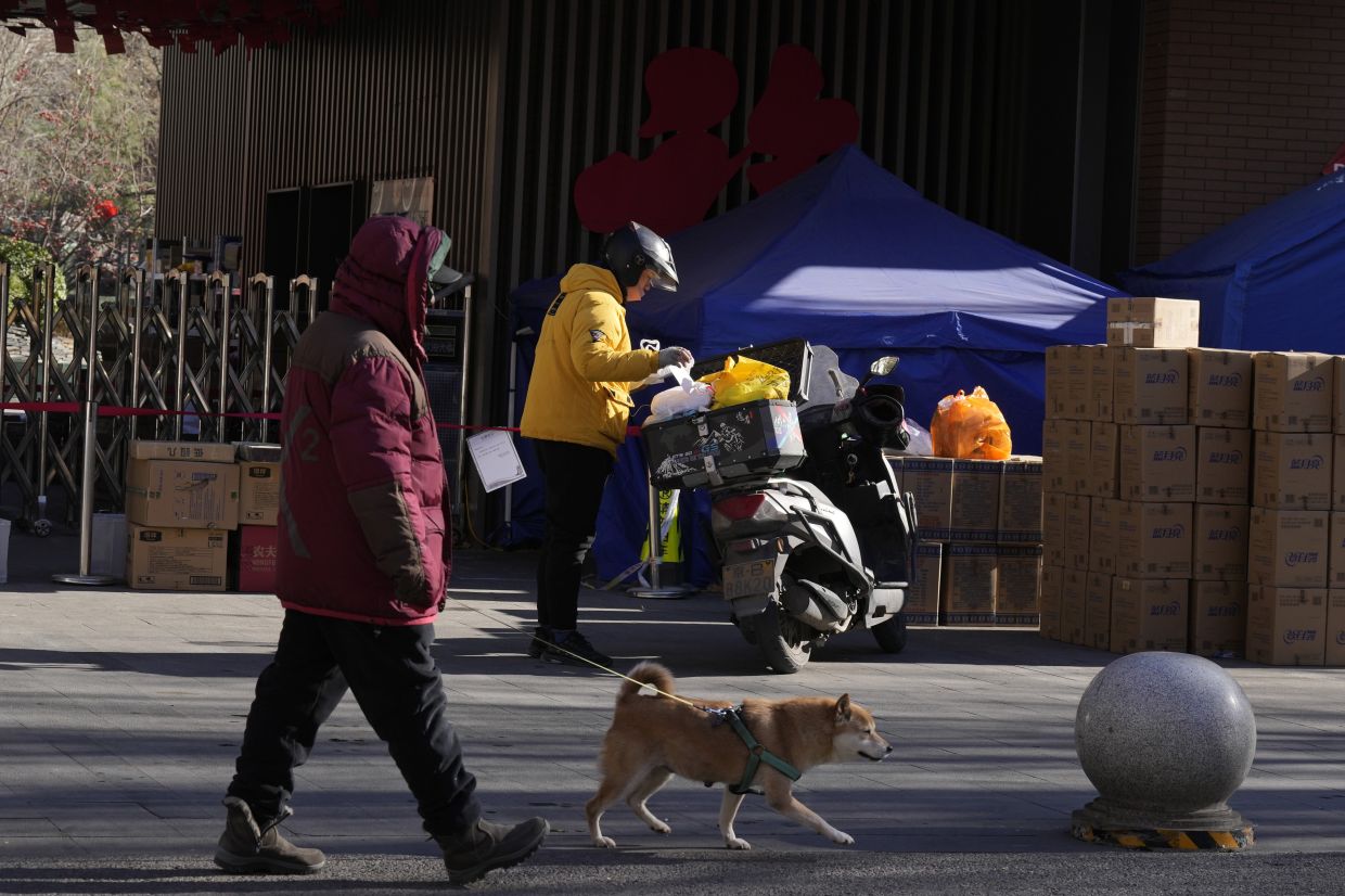 A delivery man drops off an order outside an old folks home in Beijing, Friday, Dec. 16, 2022. A week after China dramatically eased some of the world's strictest Covid-19 containment measures, uncertainty remained Thursday over the direction of the pandemic in the world's most populous nation. - AP