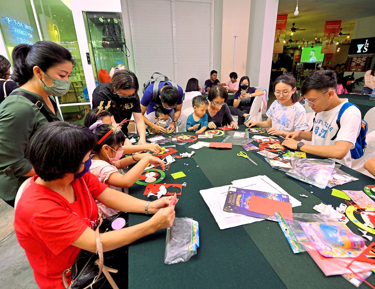 Visitors to the Magical Christmas showcase participating in an arts and craft workshop.