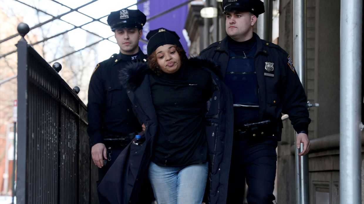 NYPD officers take suspect Shanice Aviles to Central Booking Monday after she was allegedly caught stealing Christmas presents from under a tree at Robert De Niro's townhouse on the Upper East Side. Photo: TNS