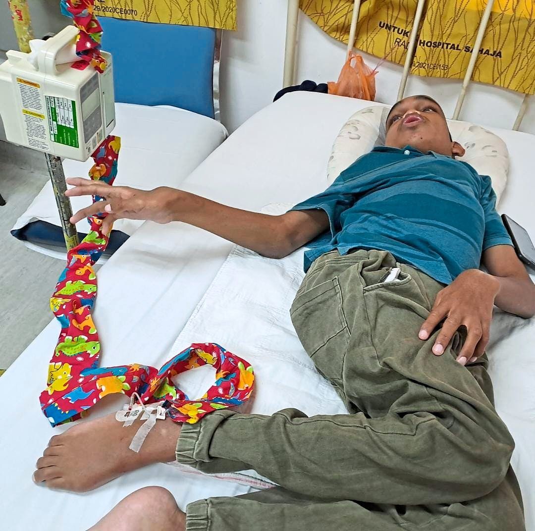 Ardi receiving his treatment at Hospital Kuala Lumpur. He is receiving the ERT through his foot as he tends to pull out the needle when it is inserted in his hand. — MAISARAH BADARUDDIN