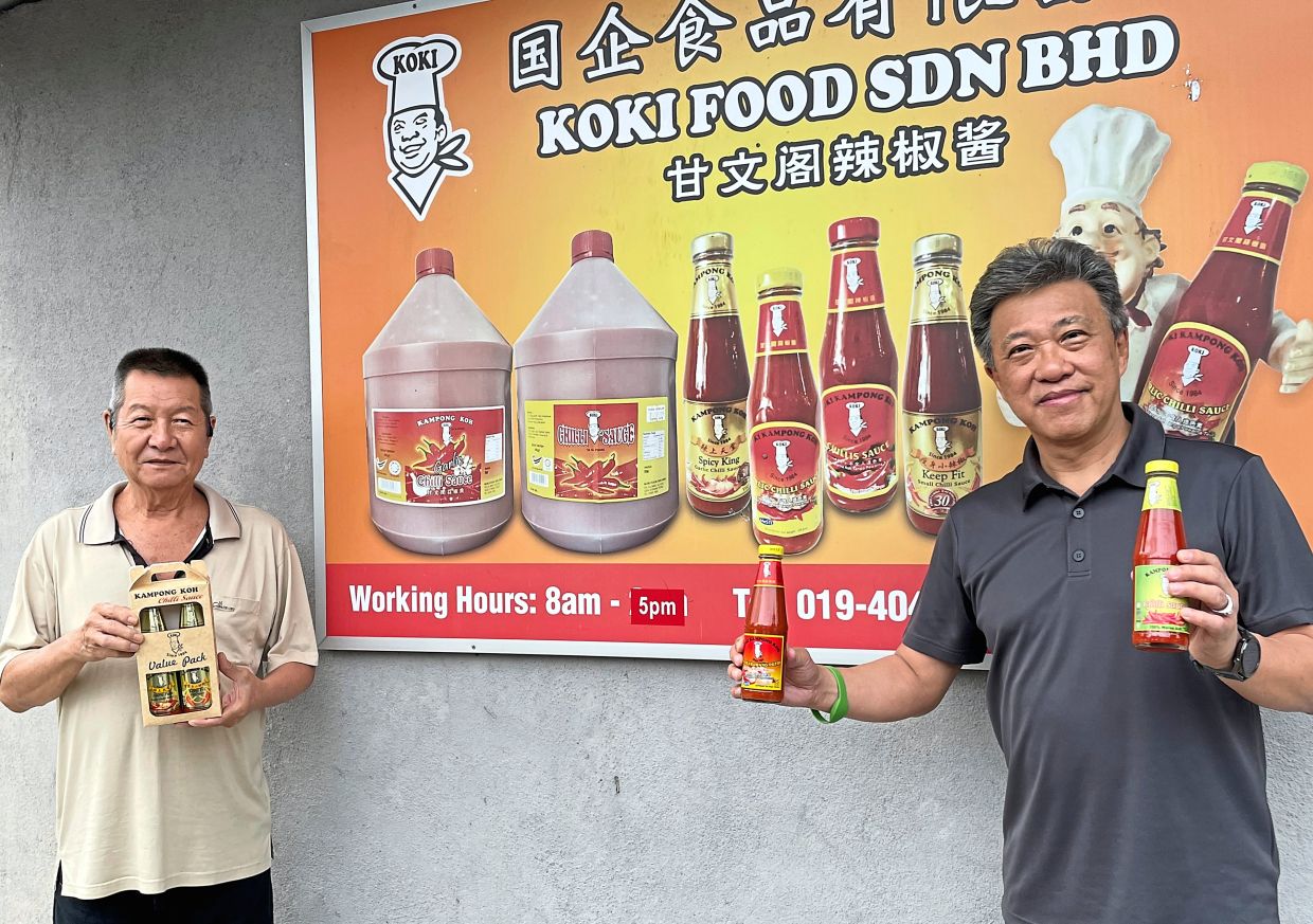 The writer (right) with Ku Sok Han, the boss of the famous dim sum chilli sauce, in Kampong Koh, Sitiawan.