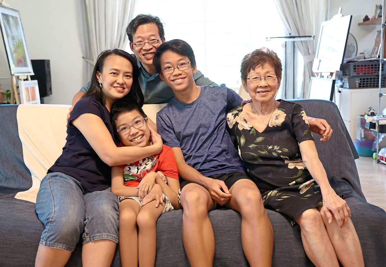 Family support: (From left, seated) Yap, Branden, older son Jaden who also has the rare condition of growth hormone deficiency, paternal grandmother Chin Lin Ngook and Lim (standing behind) at their home.