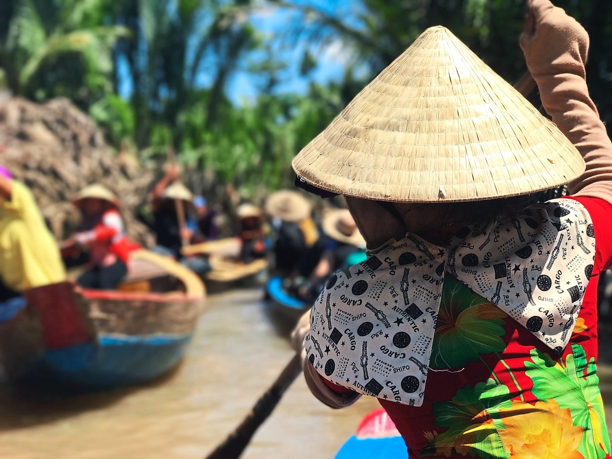 Take a boat ride along the Mekong Delta in Vietnam. — ANNE LIN/Unsplash