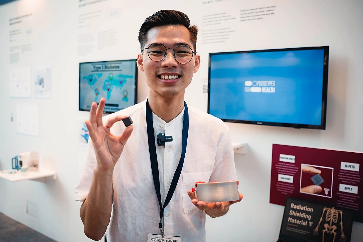 Ng holding the Bismuth and Polyethylene Terephthalate Glycol (Bi-PETG) material and a customisable collar radiation shield.