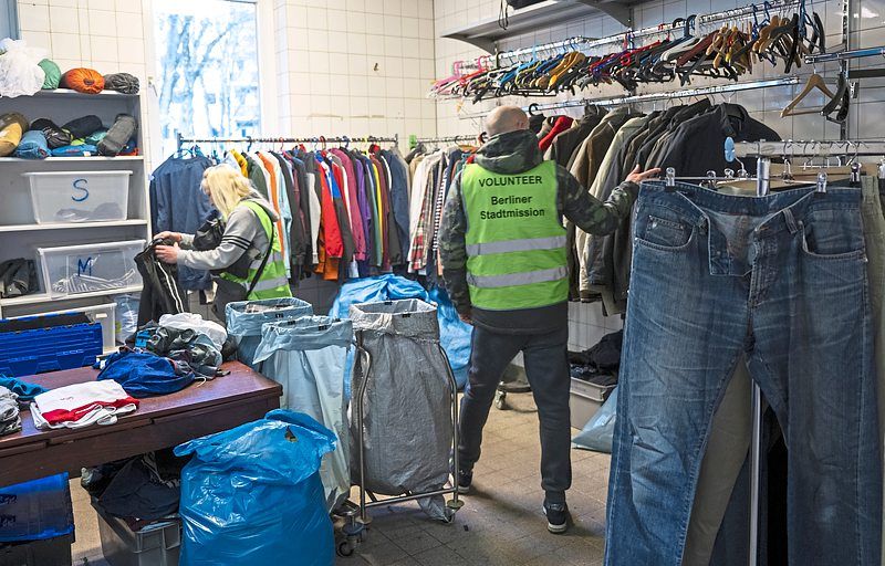 Donated clothing hangs on the clothes rails at a charity which also runs an emergency shelter for homeless people and an outpatient clinic for those in need who are not insured. 