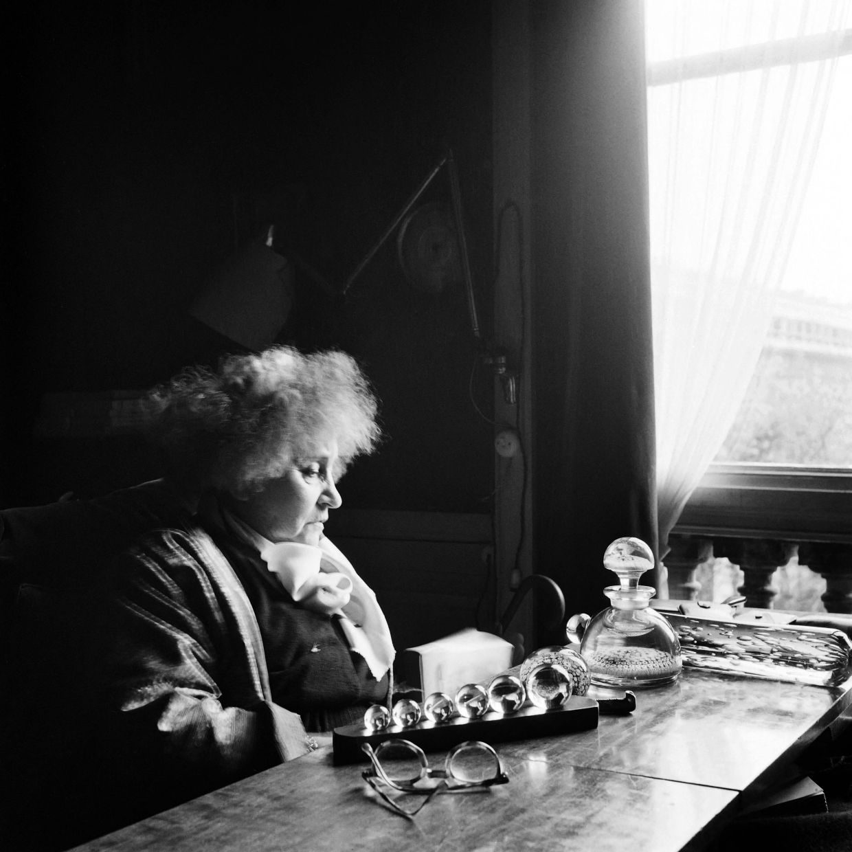 A portrait from 1952 shows French writer Colette with glass balls from her collection, taken at her Parisian home. Photo: AFP