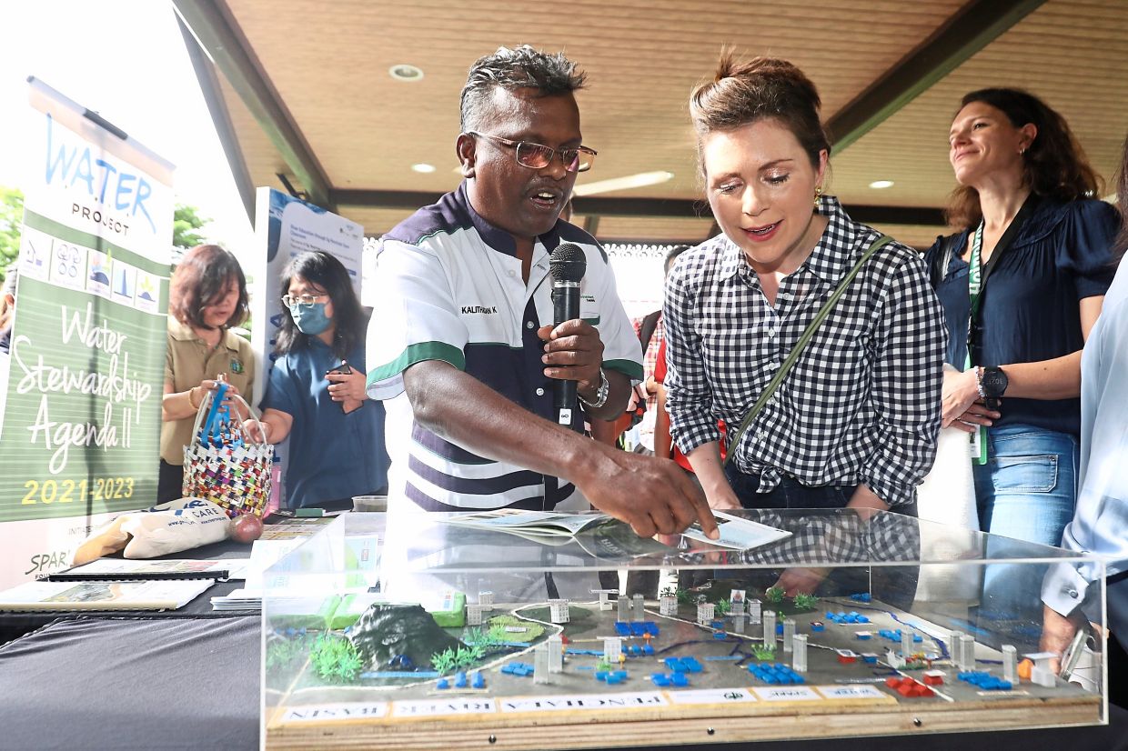 Kalithasan (left) briefing Tank on river network and rehabilitation programmes after the launch at Sungai Penchala Information Centre in Petaling Jaya.