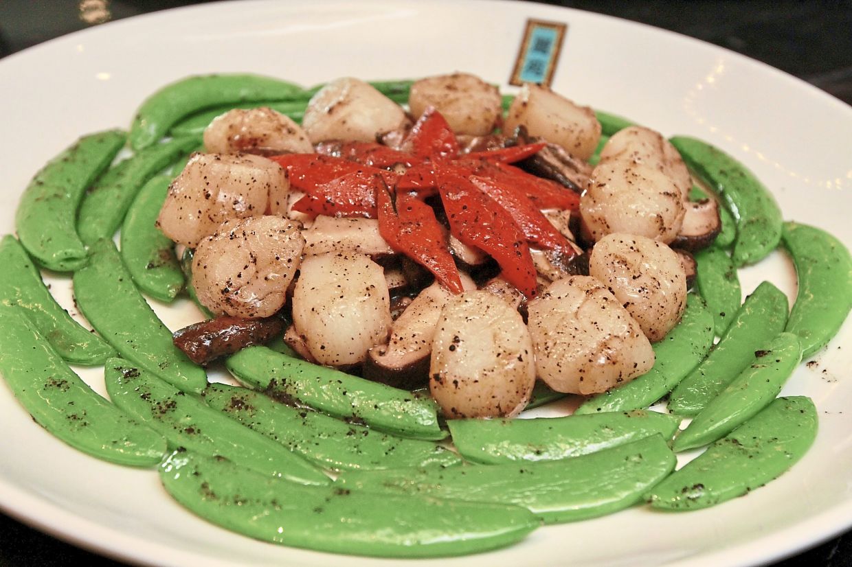 Stir-fried Australian Scallops with Sweet Peas and Truffle Sauce.