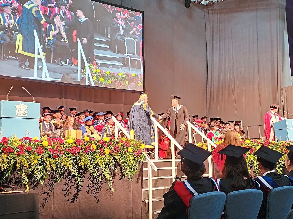 Siew (right) receiving his MBA at the University of Gloucestershire’s convocation. ‘The course brings together entrepreneurs from all walks of life,’ he said.