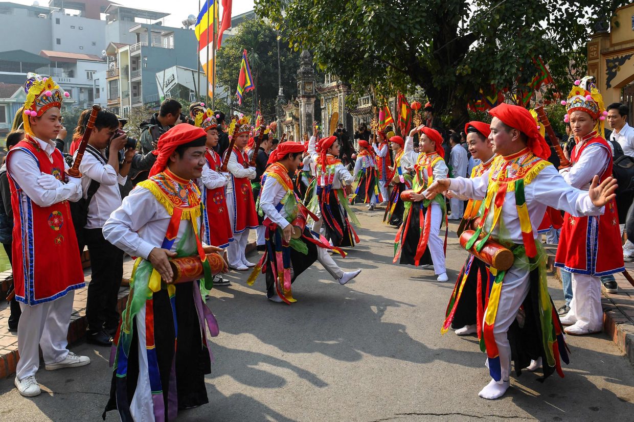 Performers taking part in the traditional Trieu Khuc Village Festival in Hanoi on Monday, January 30, 2023. - AFP