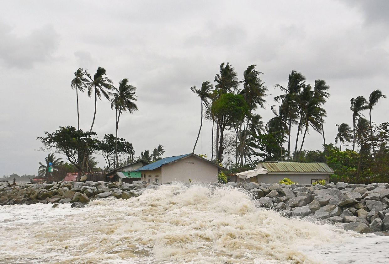 While in Pantai Kundur near Kota Baru, Kelantan, strong winds and rough seas cause waves to crash into the breakwater. — Bernama