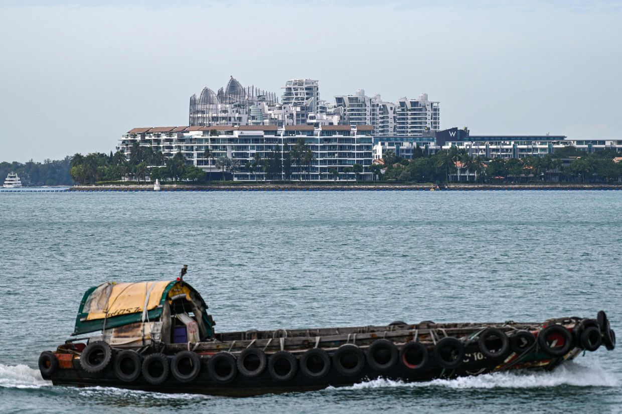 A boat on the waterway near Sentosa Cove private residential housing on Sentosa Island in Singapore. Singapore is seeing an influx of ultra-wealthy families from China looking to protect their wealth from a Communist Party that increasingly views them with suspicion. - AFP