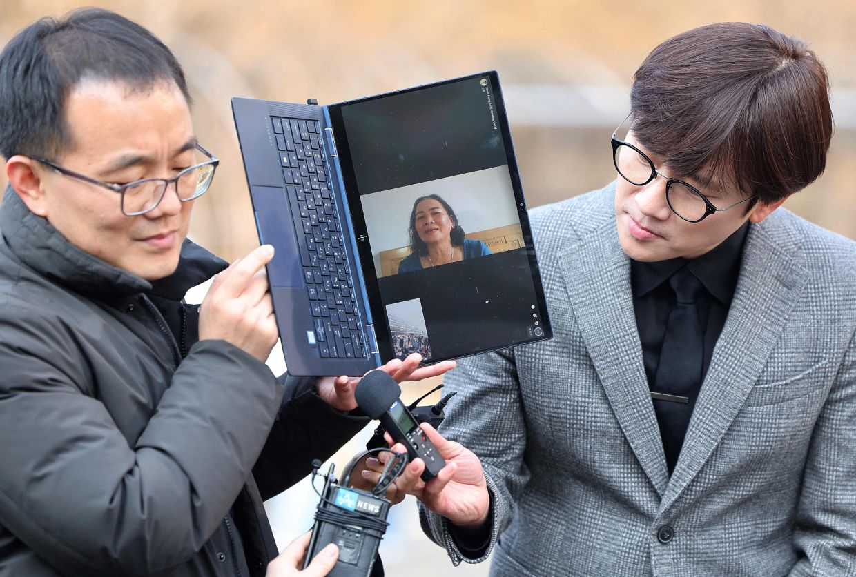 Vietnamese woman Nguyen Thi Thanh is seen on a laptop screen as she speaks to reporters via video call at the Seoul Central District Court in Seoul on Tuesday, February 7, 2023.A Seoul court delivered a landmark ruling on February 7, holding the South Korean government accountable for a massacre committed by its soldiers in the Vietnam War, ordering it to pay compensation. - AFP