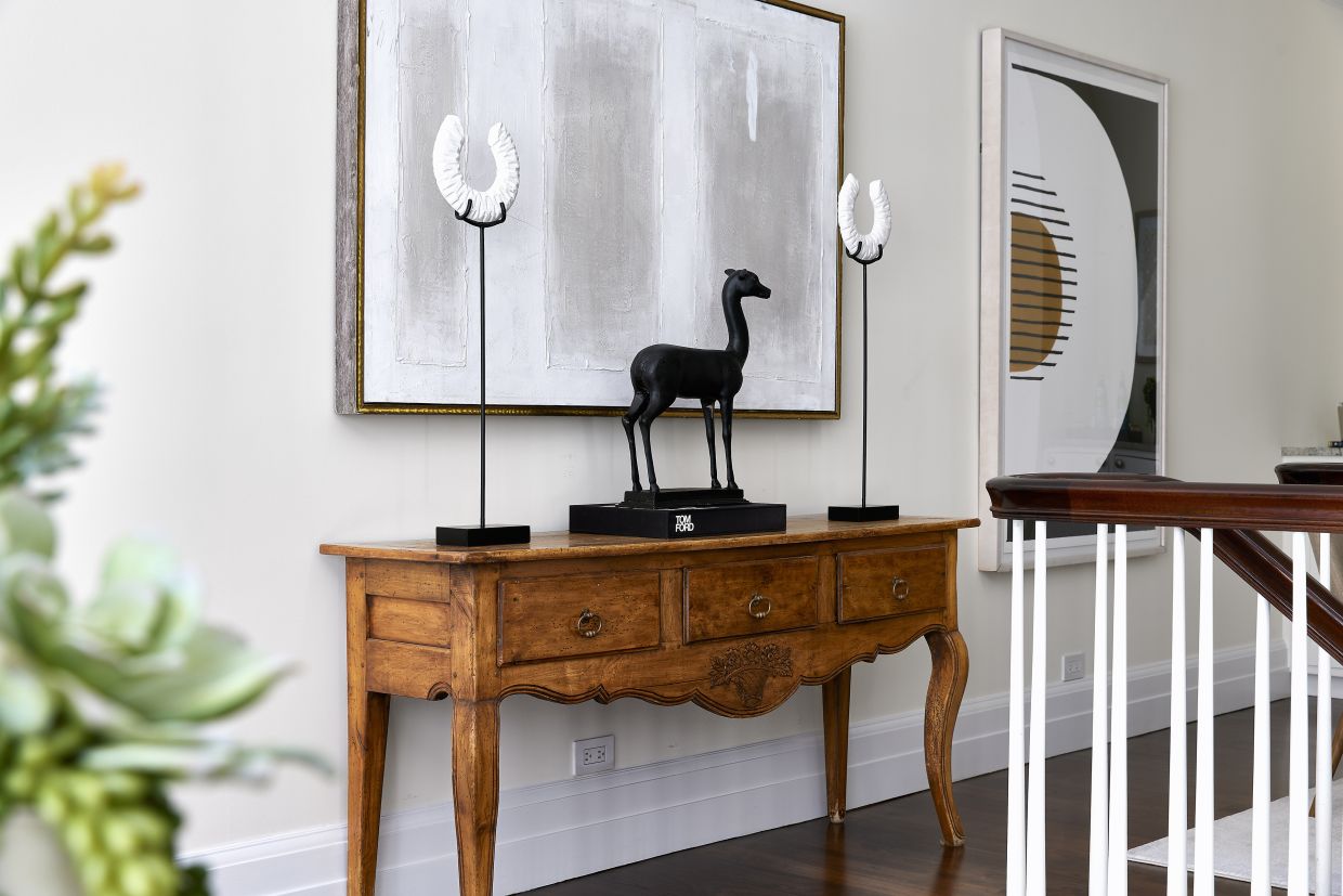 An antique console is paired with more modern pieces for a blend of old and new.