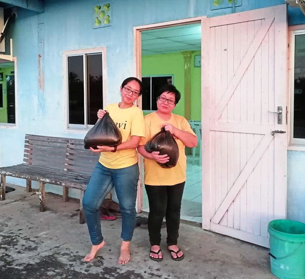 By supplying rice to Sulie, Katie Baka (right) is able to earn extra money for her family. 