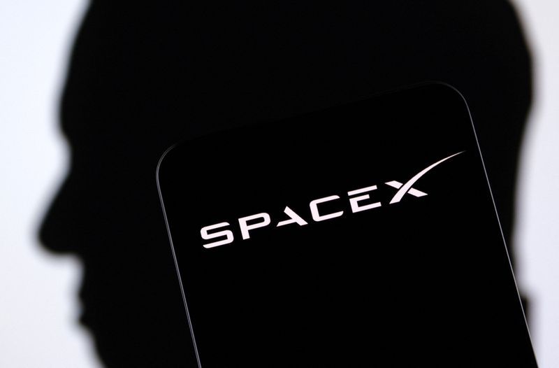 FILE PHOTO SpaceX logo and Elon Musk silhouette are seen in this illustration taken December 19 2022. REUTERSDado RuvicIllustration