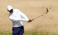 Golf-Woods apologizes for tampon prank, poised to make cut
