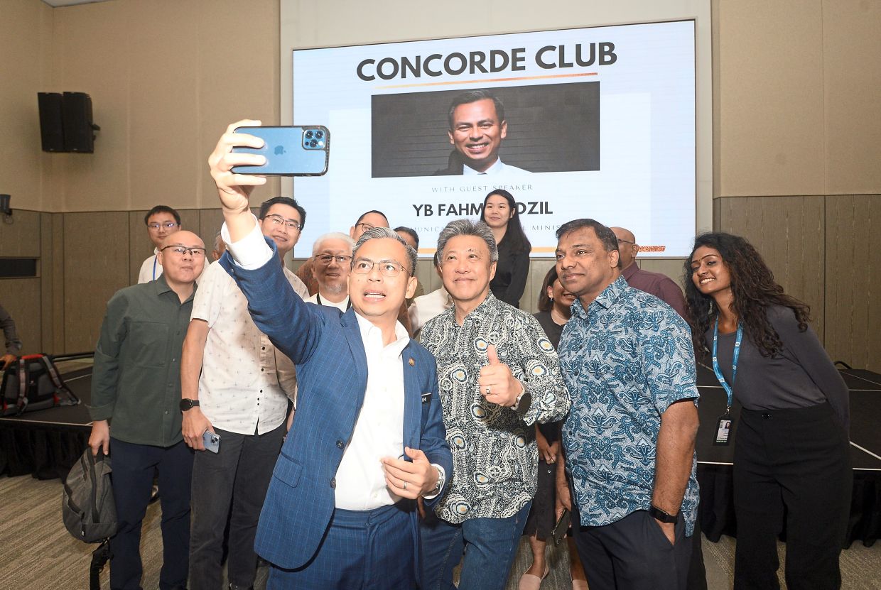 One for the album: Fahmi (with jacket) with Wong (in grey batik) and other senior editors after the forum at BBCC gallery in Kuala Lumpur. — AZHAR MAHFOF/The Star