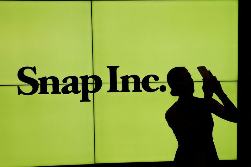 FILE PHOTO A woman stands in front of the logo of Snap Inc on the floor of the New York Stock Exchange NYSE in New York City NY U.S. March 2 2017. REUTERSLucas Jackson