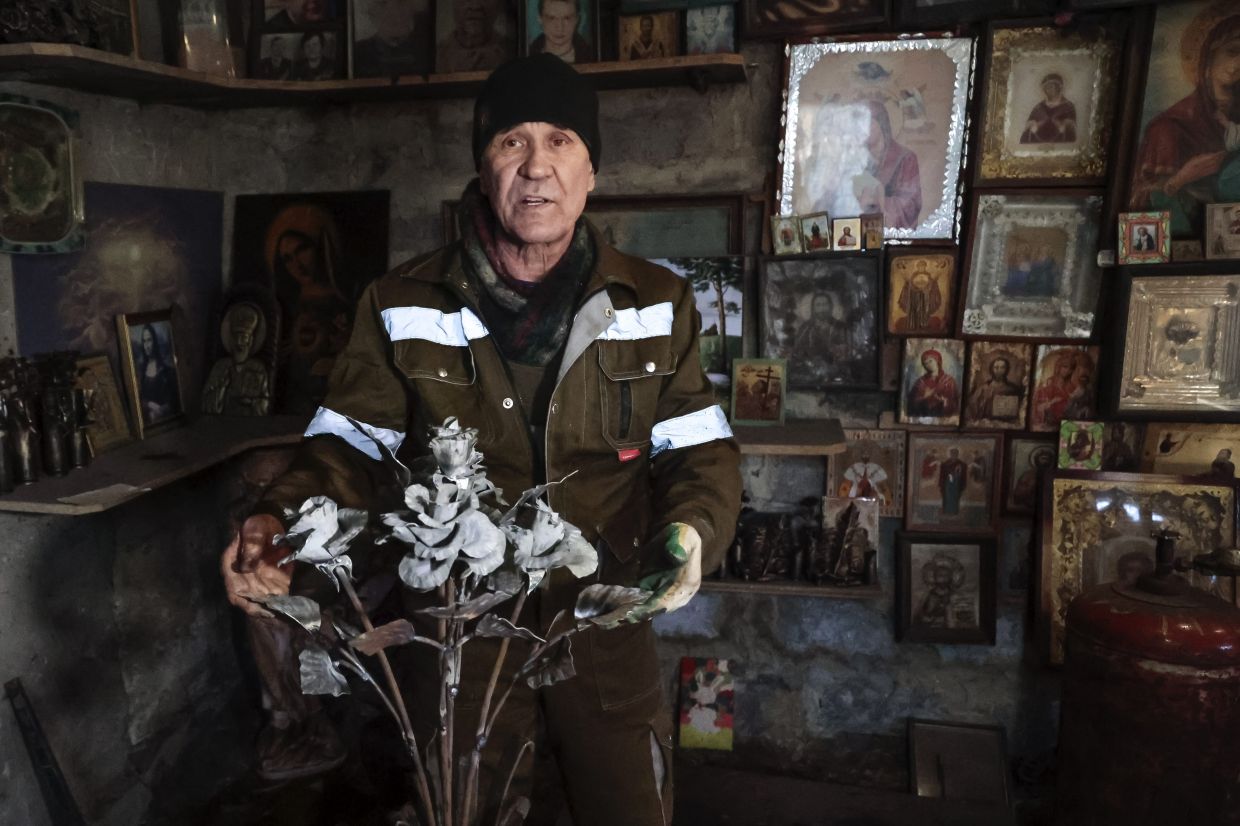 Mikhalev, trained as a welder, lives and works in a house whose fence and door are decorated with forged flowers and grapes. Photo: AP
