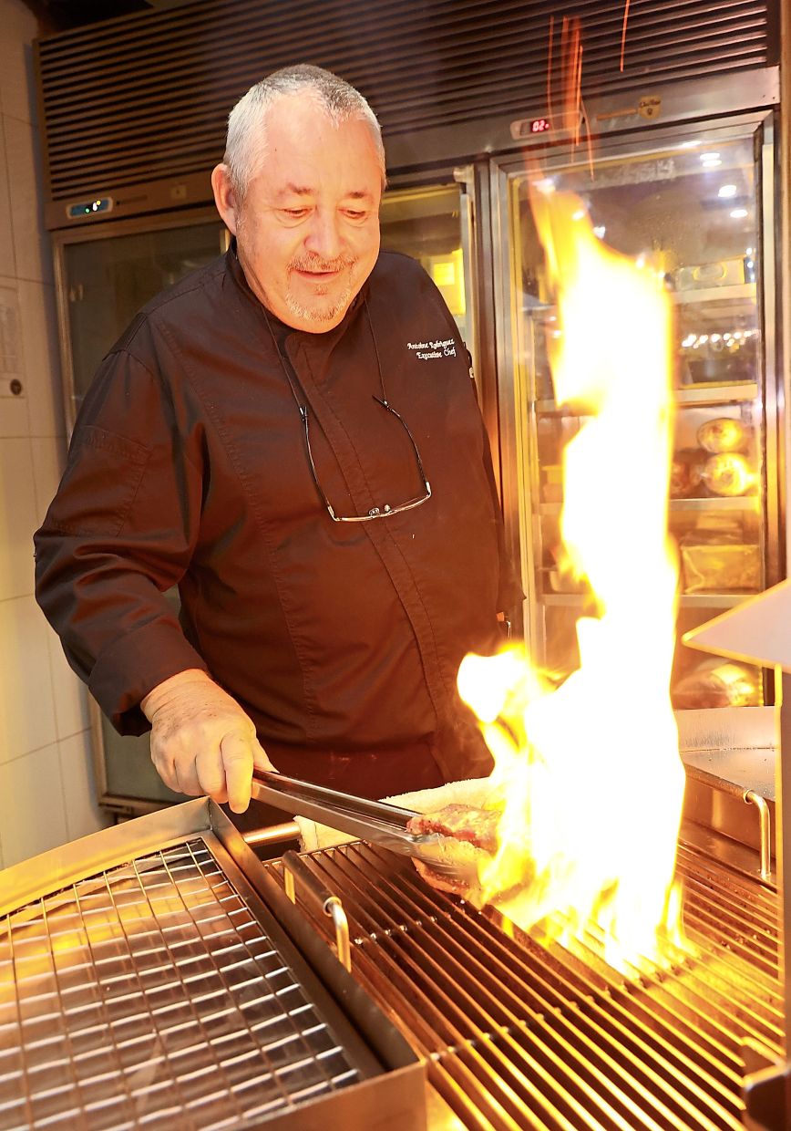 Rodriguez grilling meat over hot flames in Prime’s kitchen.