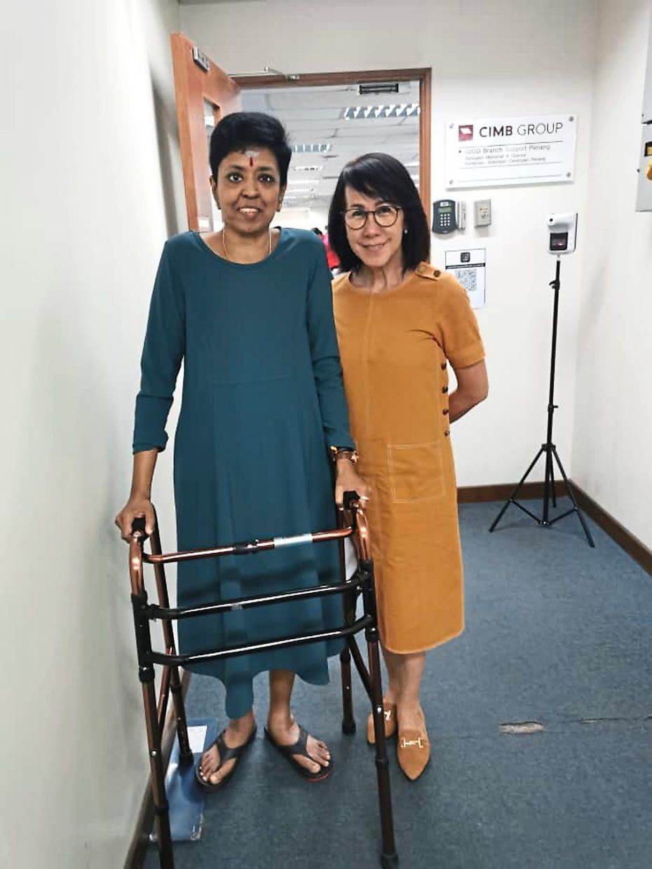 Vali, seen here with a colleague, when she was still somewhat independent and able to work in the office.